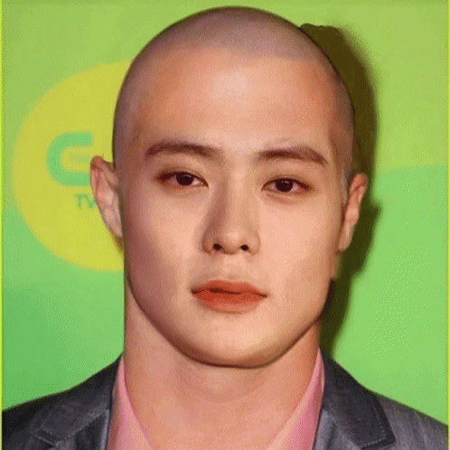 A Close Up Of A Man 'S Face With A Bald Head GIF
