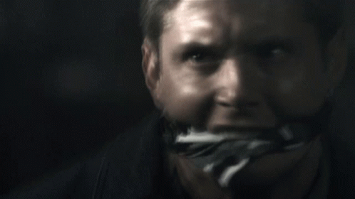 A Close Up Of A Man 'S Face With A Bandage On His Mouth GIF