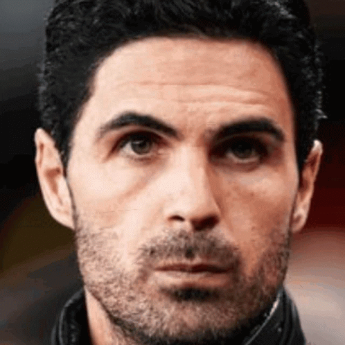 A Close Up Of A Man 'S Face With A Beard And A Black Jacket . GIF