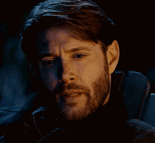 A Close Up Of A Man 'S Face With A Beard And A Black Jacket . GIF