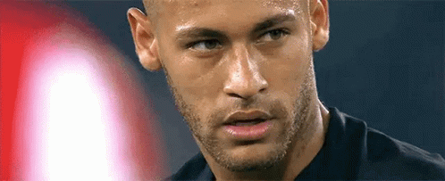 A Close Up Of A Man 'S Face With A Beard And A Black Shirt On . GIF