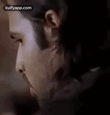 A Close Up Of A Man 'S Face With A Beard And A Piercing In His Ear . GIF