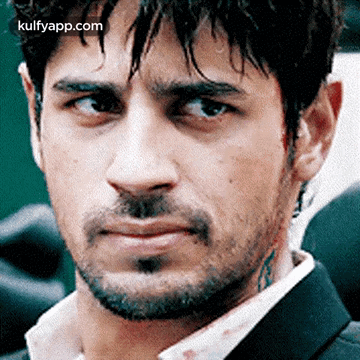 A Close Up Of A Man 'S Face With A Beard And A Tattoo On His Neck GIF