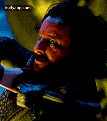 A Close Up Of A Man 'S Face With A Beard And Blood On It . GIF