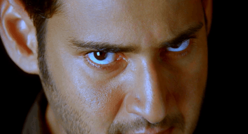 A Close Up Of A Man 'S Face With A Beard And Blue Eyes GIF