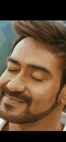 A Close Up Of A Man 'S Face With A Beard And His Eyes Closed . GIF