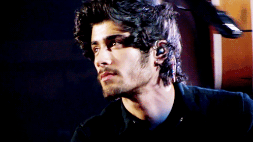 A Close Up Of A Man 'S Face With A Beard And Long Hair GIF