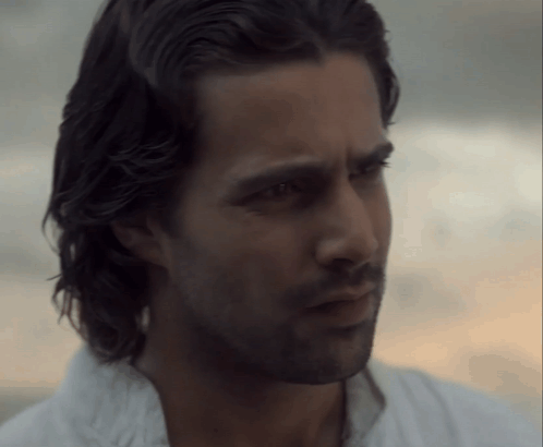 A Close Up Of A Man 'S Face With A Beard And Long Hair GIF