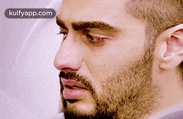 A Close Up Of A Man 'S Face With A Beard And Mustache . GIF