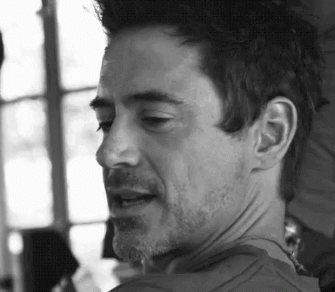 A Close Up Of A Man 'S Face With A Beard And Mustache In A Black And White Photo . GIF