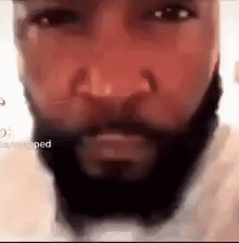 A Close Up Of A Man 'S Face With A Beard And Nose Ring . GIF