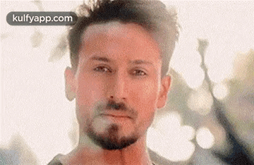 A Close Up Of A Man 'S Face With A Beard . GIF