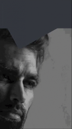 A Close Up Of A Man 'S Face With A Beard In A Black And White Photo GIF