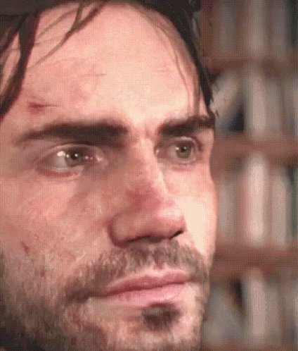 A Close Up Of A Man 'S Face With A Beard Looking At The Camera GIF
