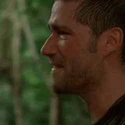 A Close Up Of A Man 'S Face With A Beard Looking At The Camera . GIF