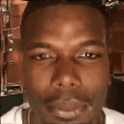 A Close Up Of A Man 'S Face With A Beard Looking At The Camera . GIF