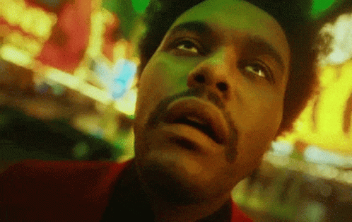 A Close Up Of A Man 'S Face With A Beard Looking Up At The Sky . GIF