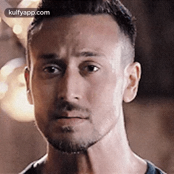 A Close Up Of A Man 'S Face With A Beard Making A Serious Face . GIF