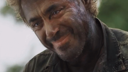 A Close Up Of A Man 'S Face With A Beard Smiling . GIF