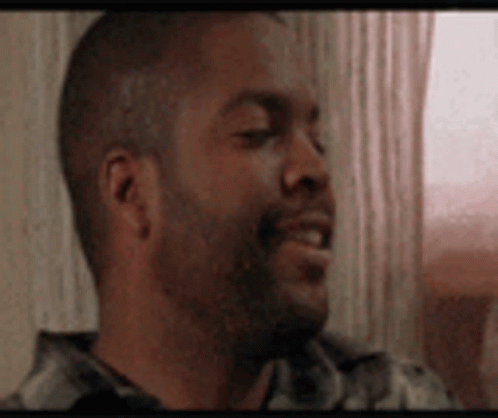 A Close Up Of A Man 'S Face With A Beard Smiling . GIF