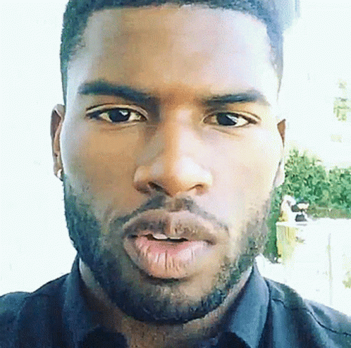 A Close Up Of A Man 'S Face With A Beard Wearing A Black Shirt GIF