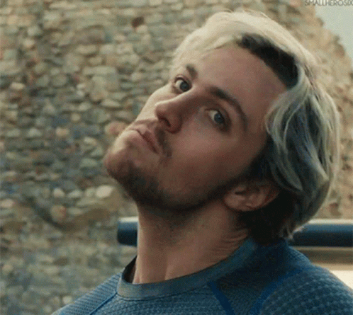 a close up of a man 's face with a beard wearing a blue sweater .