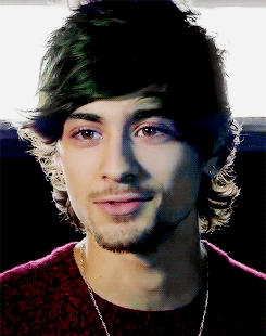 A Close Up Of A Man 'S Face With A Beard Wearing A Red Sweater GIF