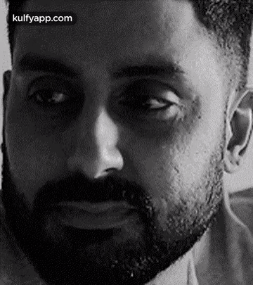 A Close Up Of A Man 'S Face With A Beard . GIF