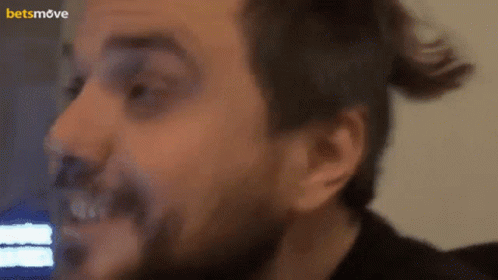 A Close Up Of A Man 'S Face With A Betsmove Logo In The Corner GIF