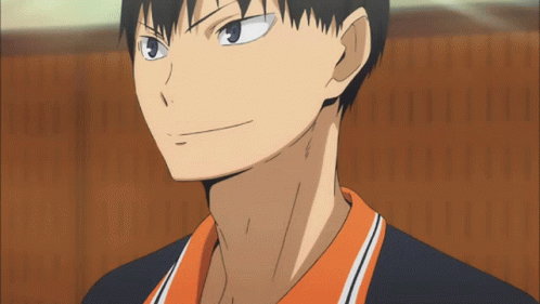 A Close Up Of A Man 'S Face With A Black And Orange Shirt GIF
