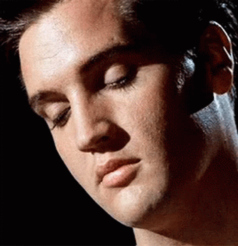 A Close Up Of A Man 'S Face With A Black Background GIF