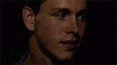 A Close Up Of A Man 'S Face With A Black Background GIF