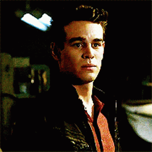 A Close Up Of A Man 'S Face With A Black Jacket On GIF