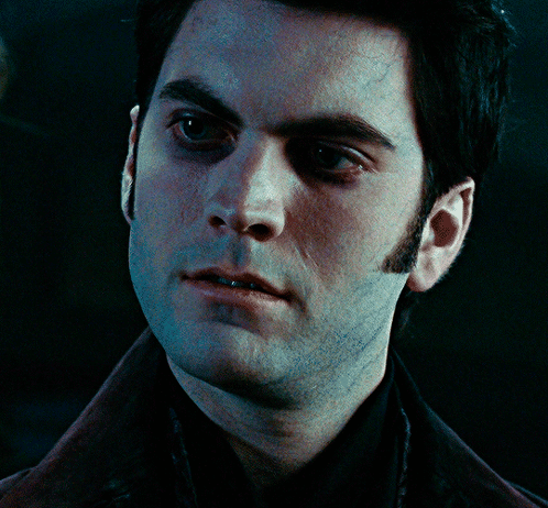 A Close Up Of A Man 'S Face With A Black Shirt On GIF