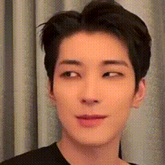 A Close Up Of A Man 'S Face With A Black Shirt On . GIF
