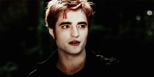 A Close Up Of A Man 'S Face With A Black Shirt On And A Dark Background . GIF