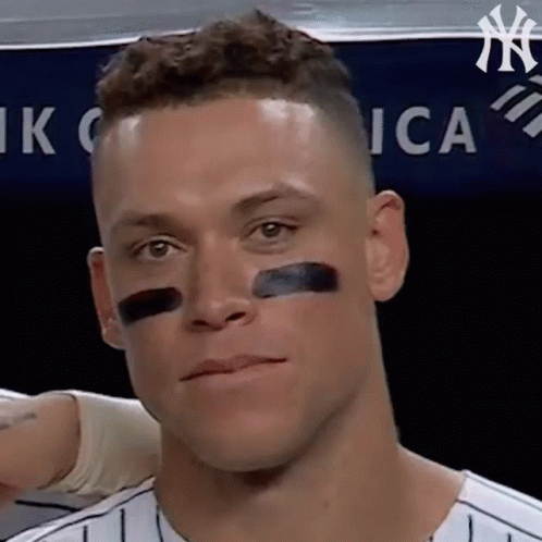 A Close Up Of A Man 'S Face With A Black Stripe On His Nose . GIF