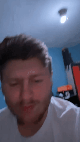 A Close Up Of A Man 'S Face With A Blue Background GIF