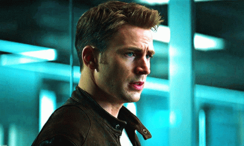 A Close Up Of A Man 'S Face With A Blue Background GIF