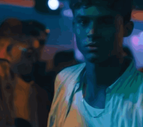 A Close Up Of A Man 'S Face With A Blue Background GIF