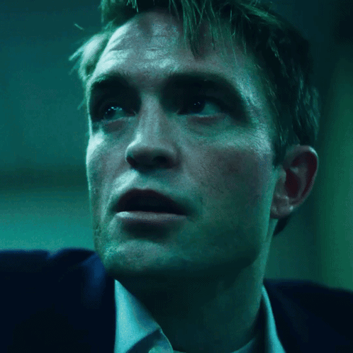 A Close Up Of A Man 'S Face With A Blue Background GIF