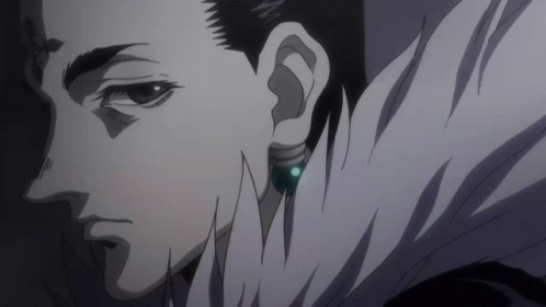 A Close Up Of A Man 'S Face With A Blue Earring In His Right Ear GIF