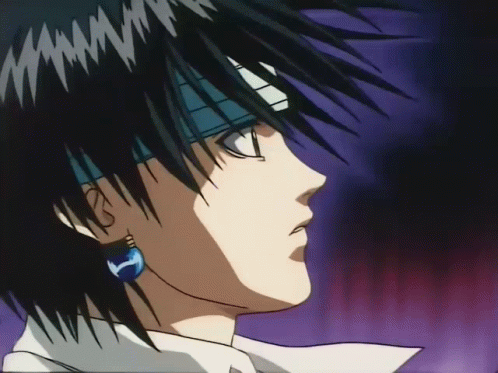 A Close Up Of A Man 'S Face With A Blue Earring GIF