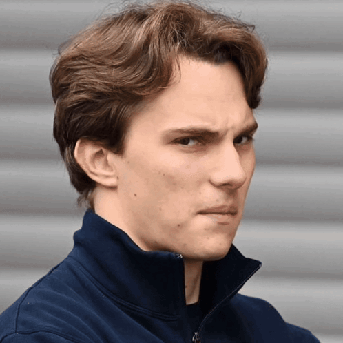 A Close Up Of A Man 'S Face With A Blue Jacket On GIF