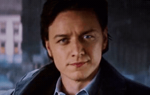 A Close Up Of A Man 'S Face With A Blue Shirt And A Blue Jacket . GIF