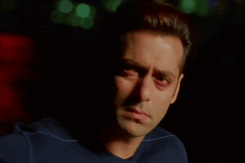 A Close Up Of A Man 'S Face With A Blue Shirt On GIF