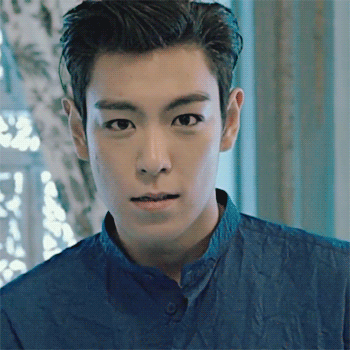 A Close Up Of A Man 'S Face With A Blue Shirt On GIF