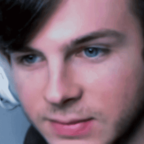 A Close Up Of A Man 'S Face With A Blurred Background GIF