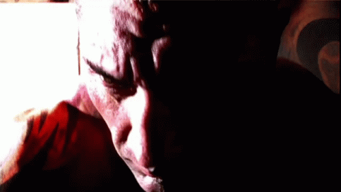 A Close Up Of A Man 'S Face With A Blurred Background GIF