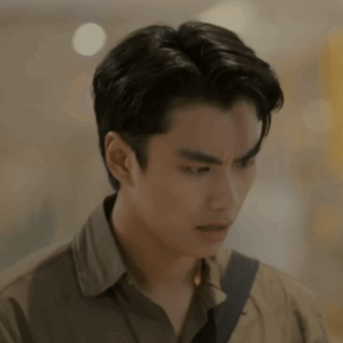 A Close Up Of A Man 'S Face With A Blurred Background And A Shoulder Strap . GIF
